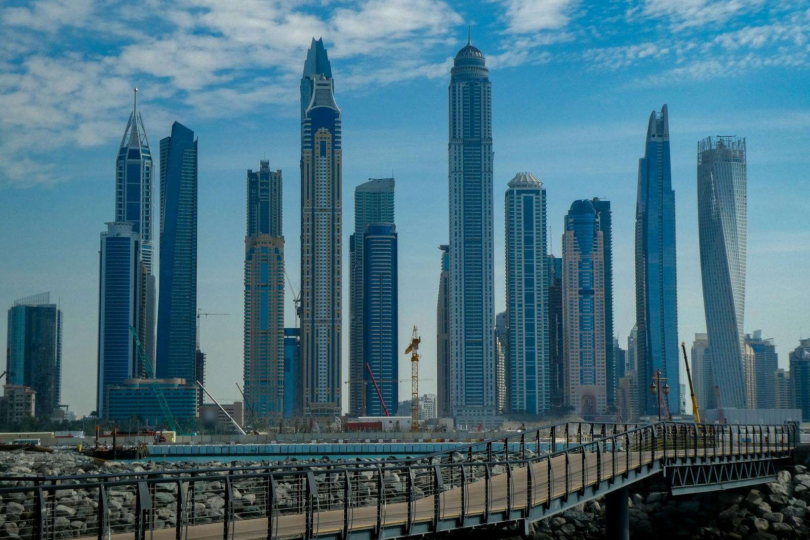 أبراج سكنية في دبي مارينا من ممشى على الواجهة البحرية في يوم صافٍ